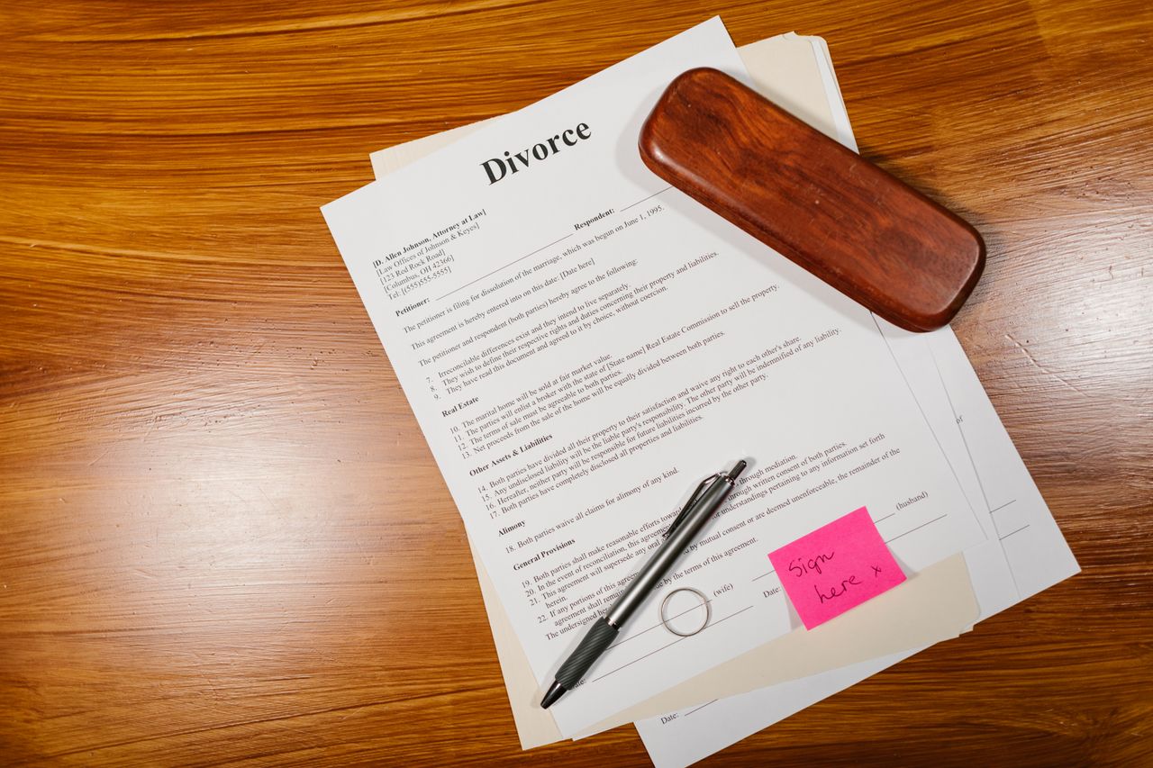 Legal documents, pen and supporting evidence prepared for careful review.